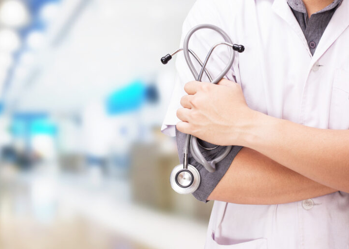 Doctor with a stethoscope in the hands and hospital background Doctor with a stethoscope in the hands and hospital background.